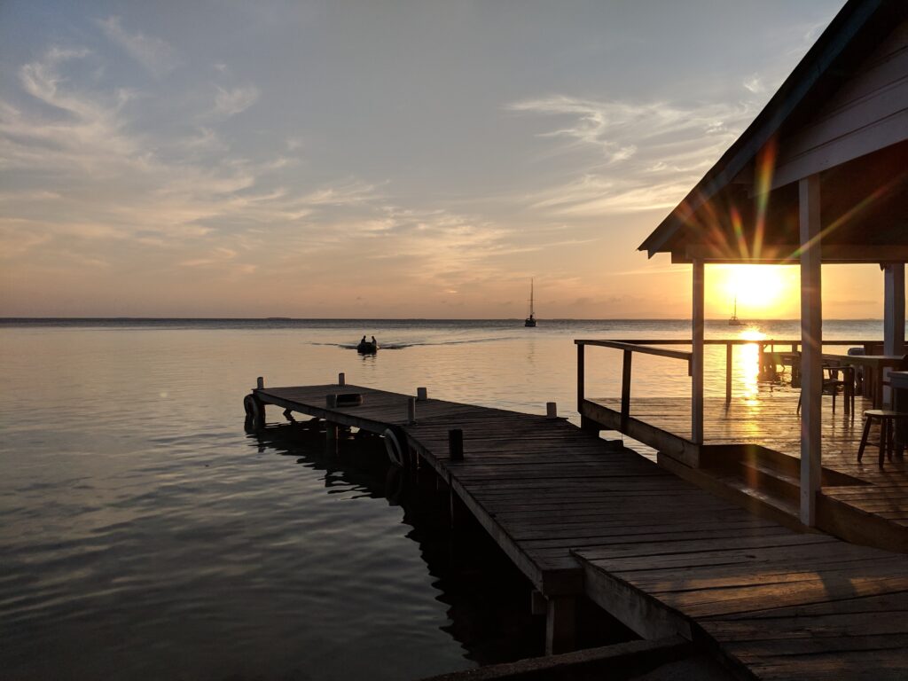 Watching the sunset from IZE Belize's pier at South Water Caye