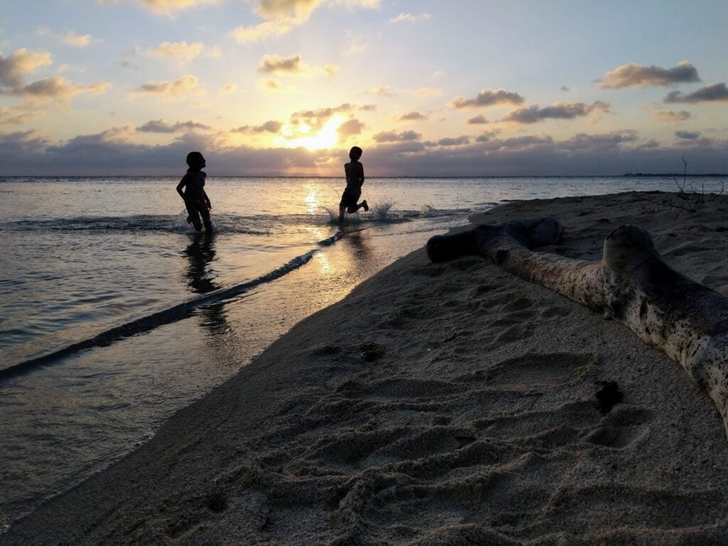 Playing in water at sunset on South Water Caye.