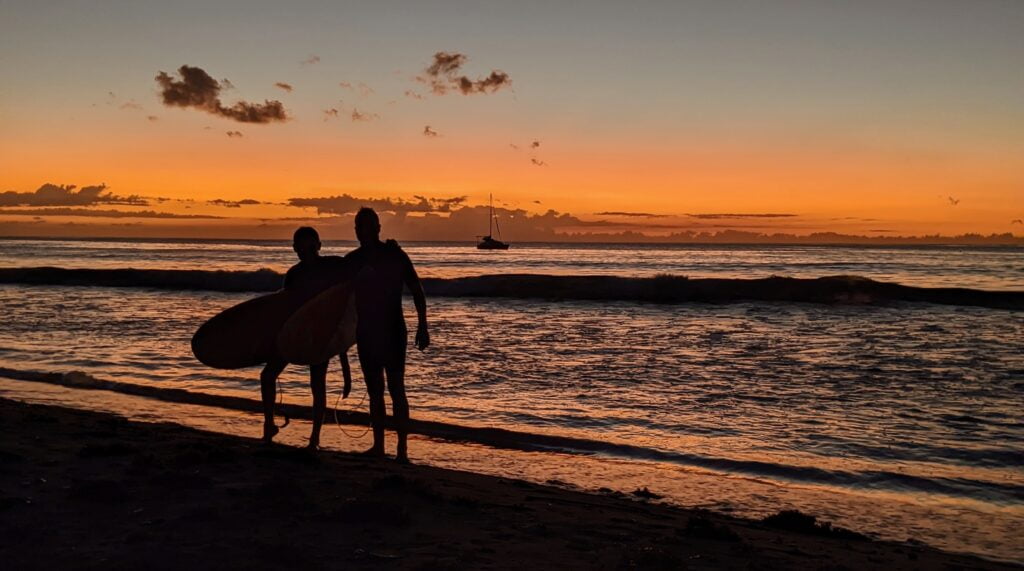 Surfers at sunset